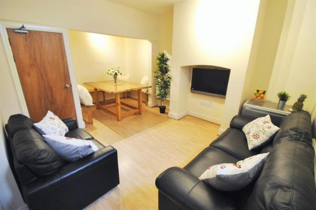 Bright, modern communal living room with two co...