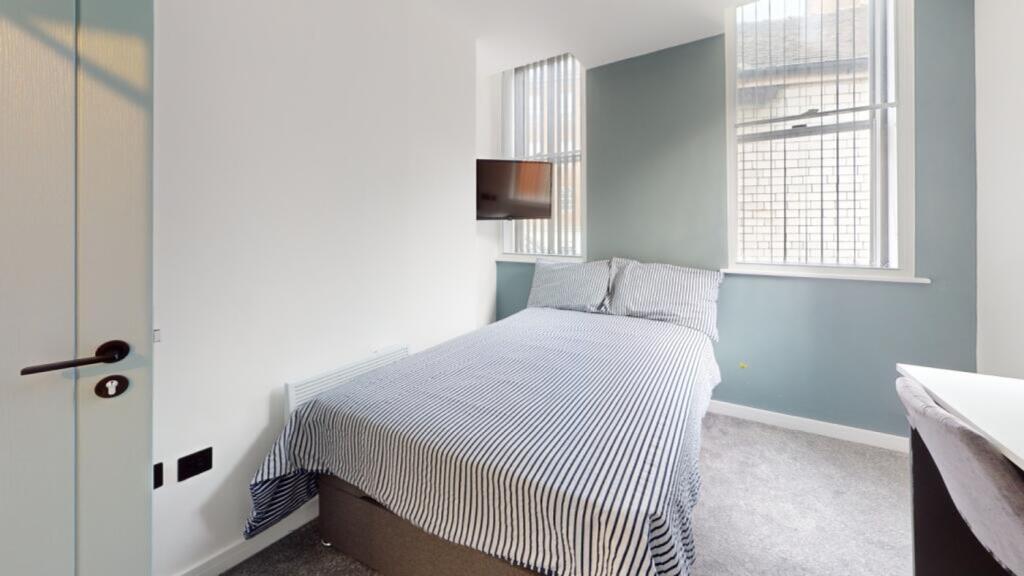 A stylish and inviting double bedroom with ampl...