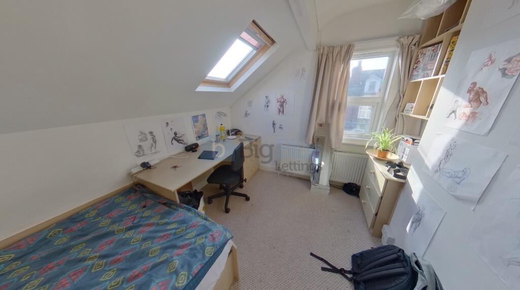 Bright single bedroom with a slanted ceiling, f...