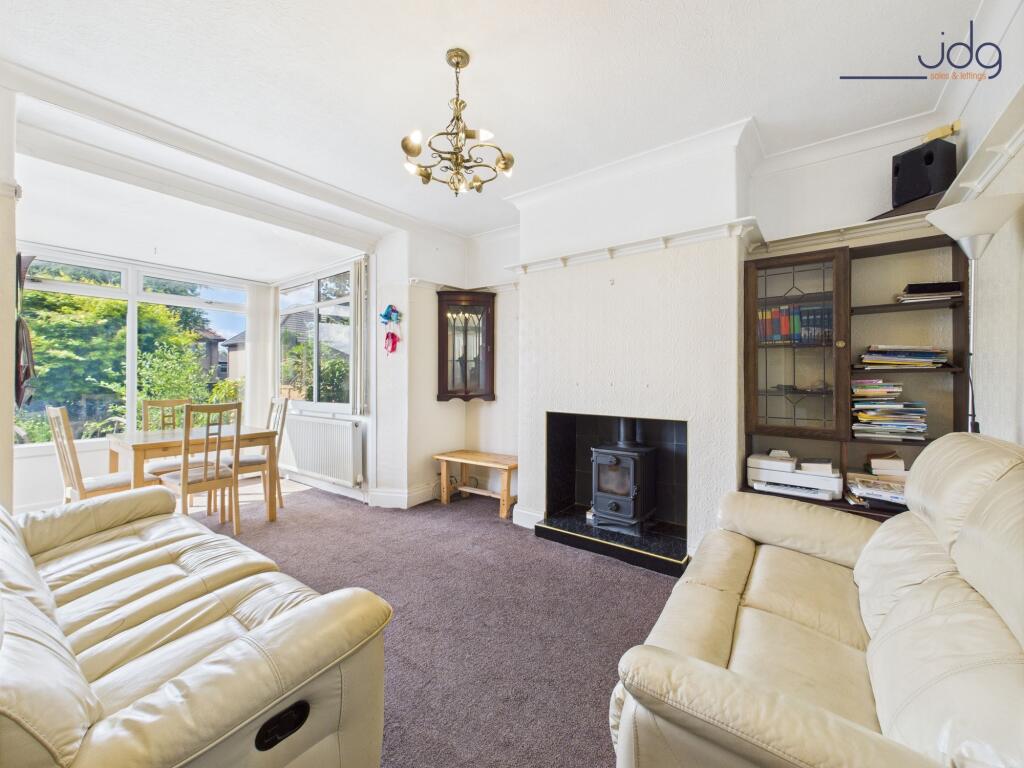 Living Room with extended sunroom and wood-burning stove