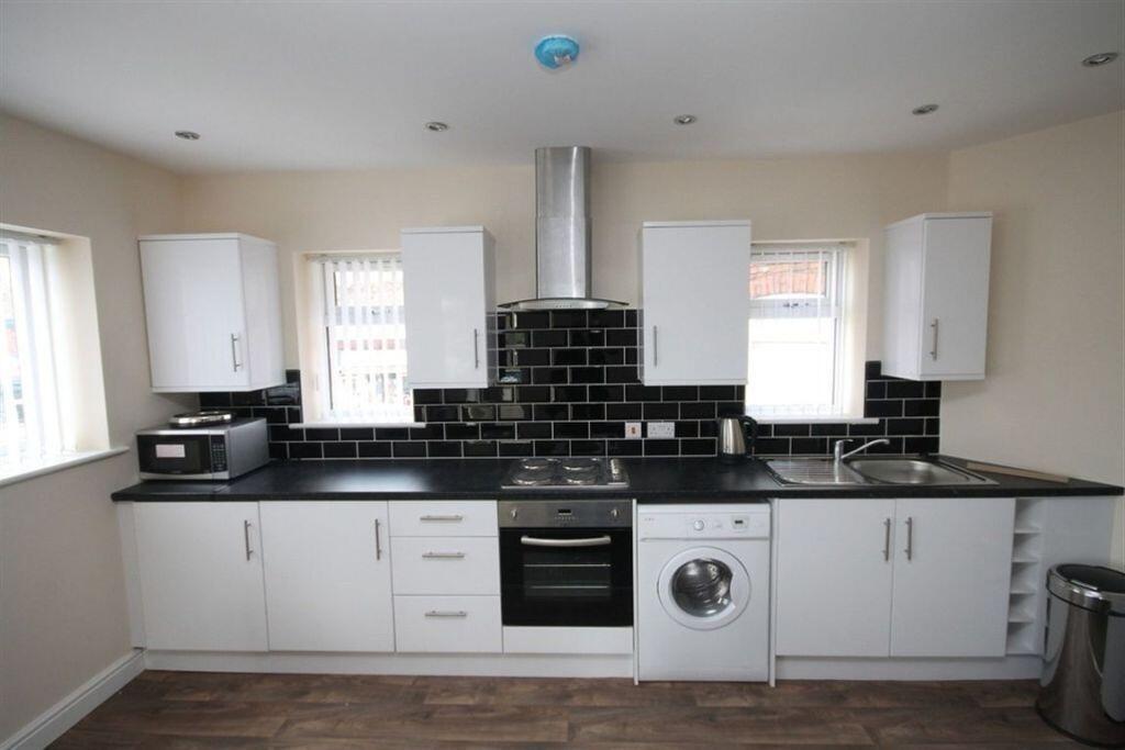 Modern and well-maintained kitchen with black c...