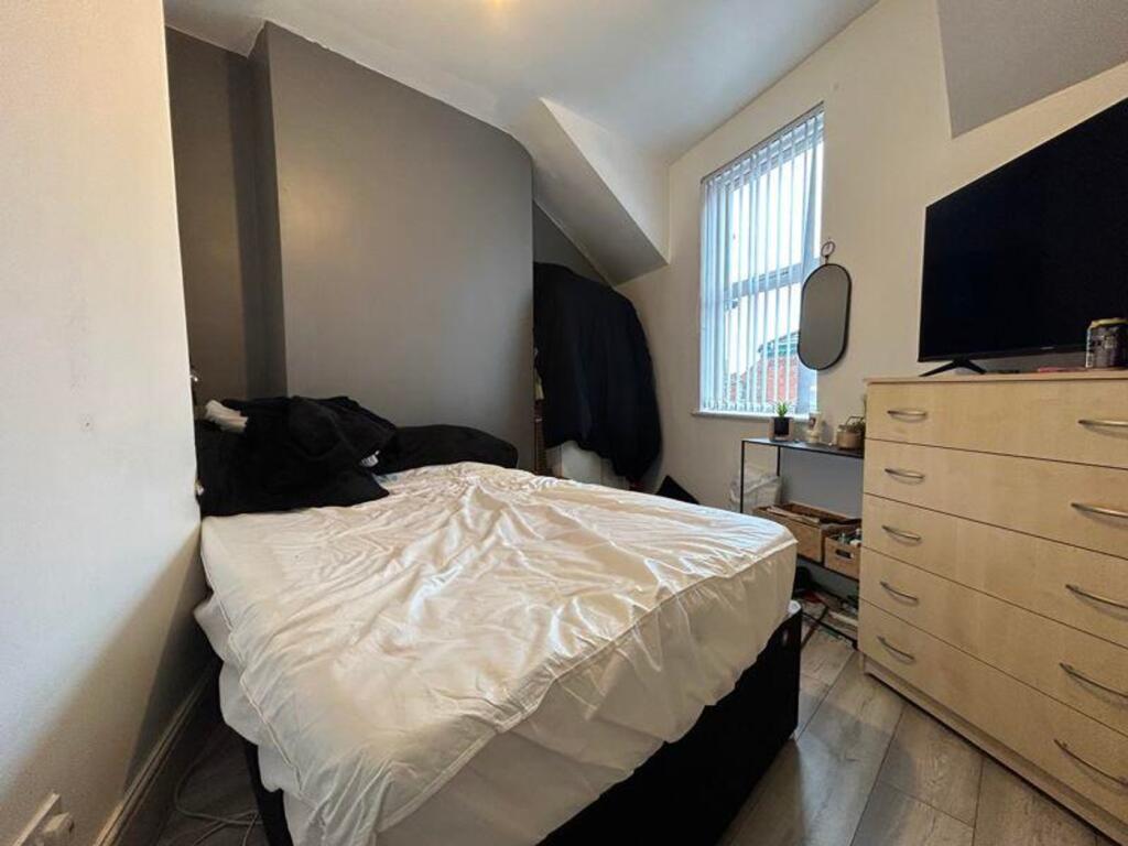 A cozy double bedroom featuring ample natural l...