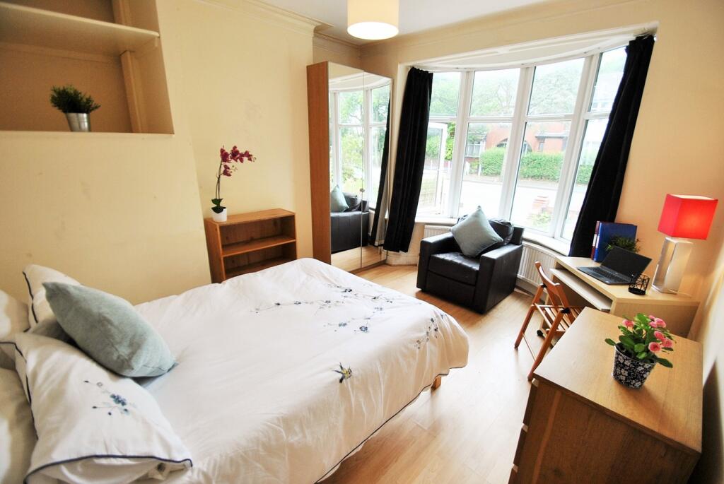 A bright and inviting double bedroom featuring ...