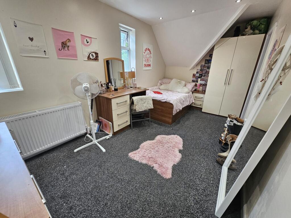 A cozy bedroom featuring a double bed, wardrobe...