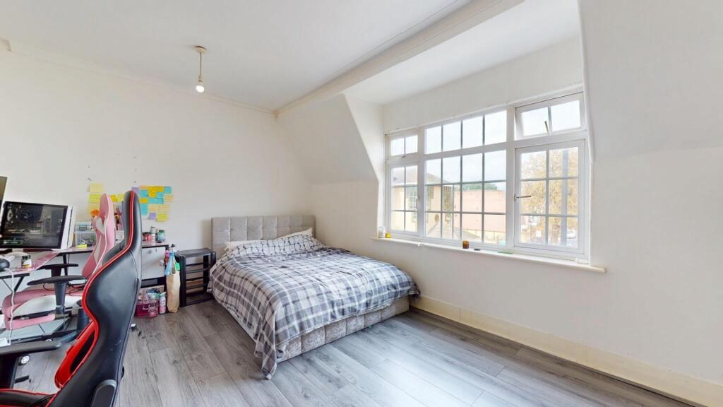 Bright and cozy double bedroom featuring a comf...