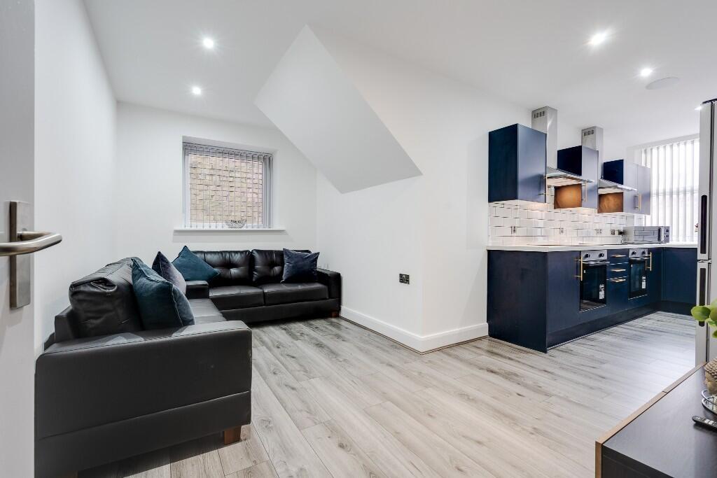 This stylish living room features a modern desi...
