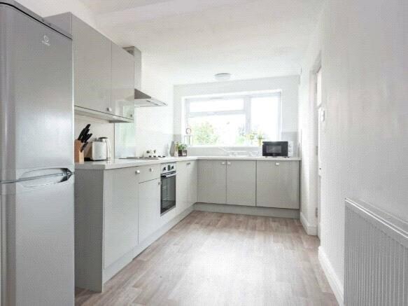 Bright and modern kitchen featuring sleek grey ...