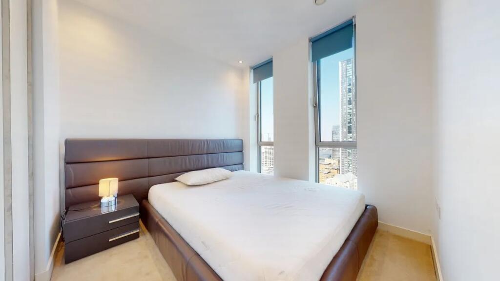 Bright and modern double bedroom featuring a la...