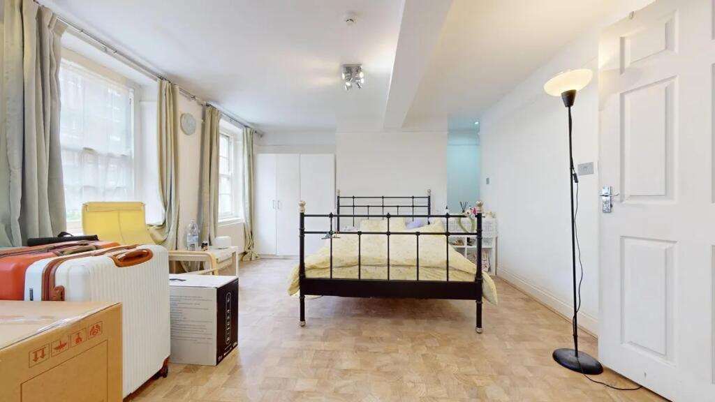 Bright and spacious master bedroom featuring a ...