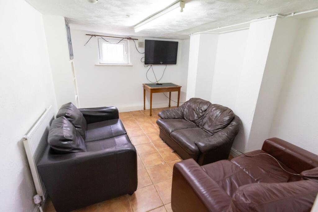 A cozy living room featuring three comfortable ...