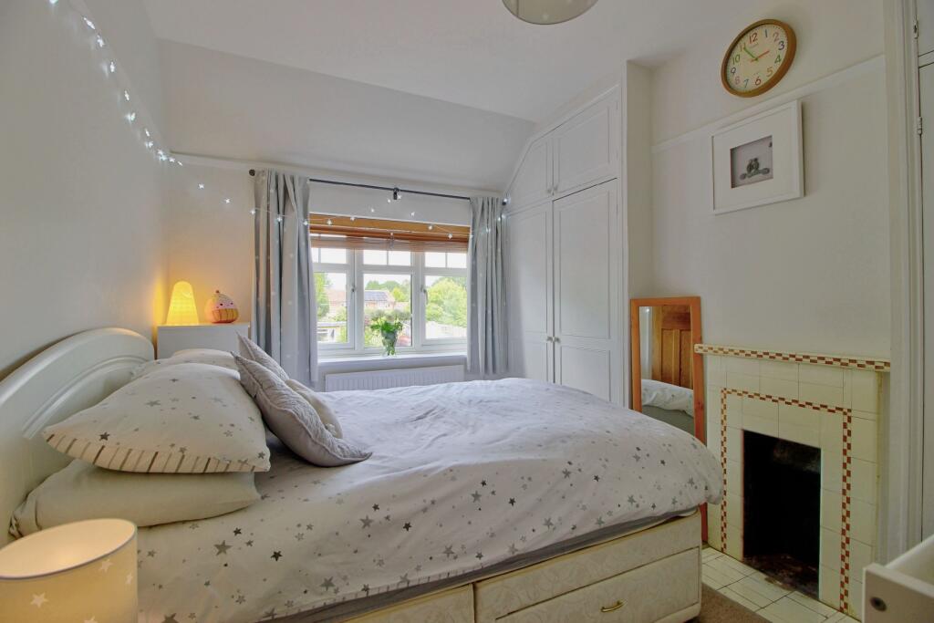 Bedroom Two with storage and feature fireplace