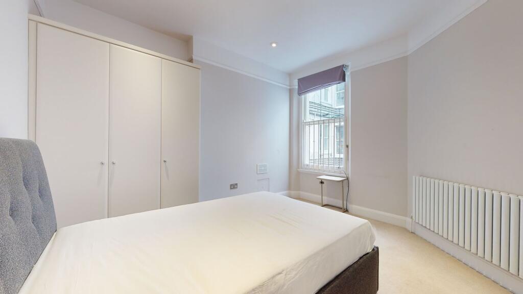 A bright and tidy double bedroom featuring a co...