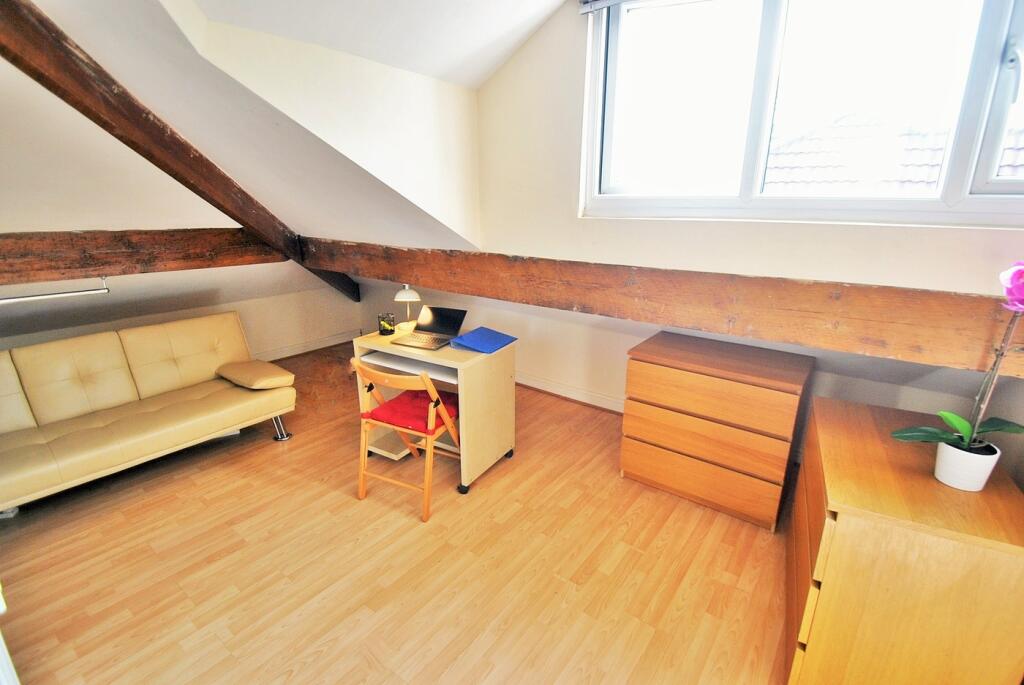 A cozy and well-lit double bedroom featuring a ...