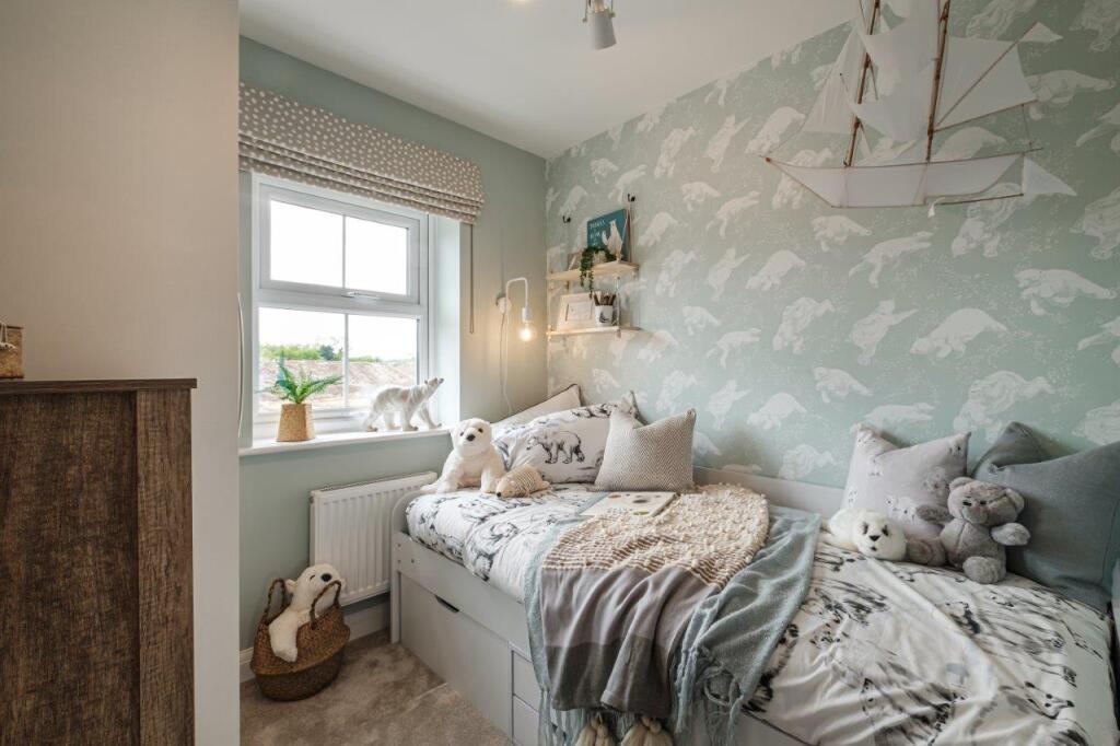 Single children's bedroom decorated with animal themed prints