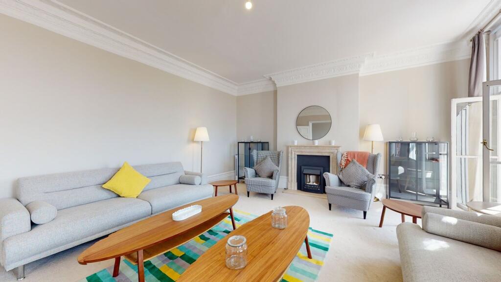 A bright and inviting living room featuring ele...