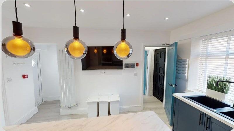 Bright and modern kitchen featuring sleek cabin...