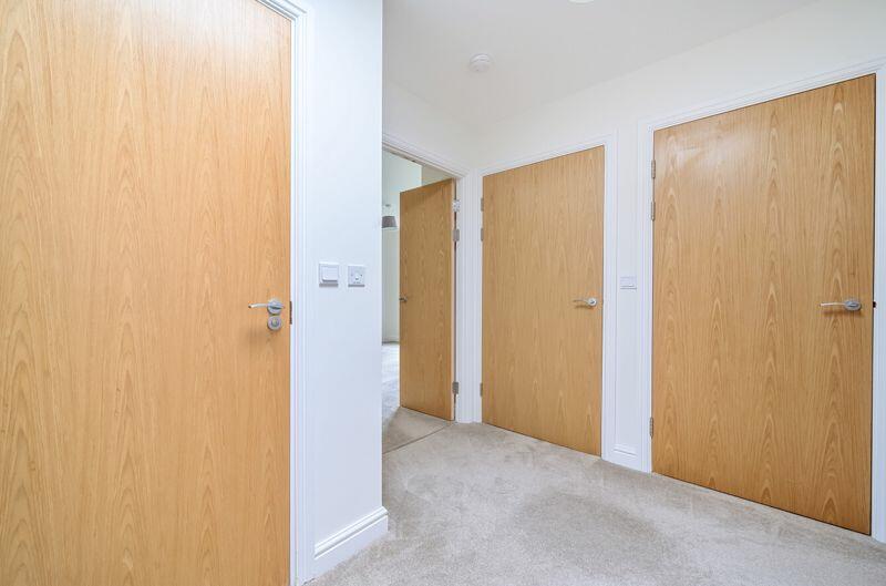 Hallway with storage cupboards
