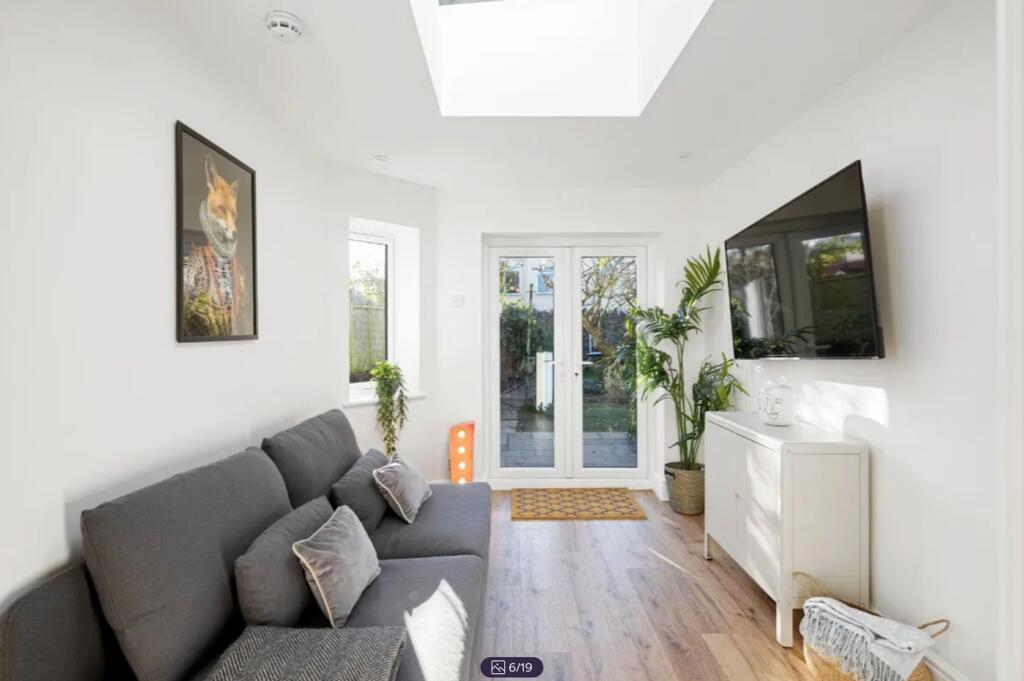 A spacious and bright modern living room with a...
