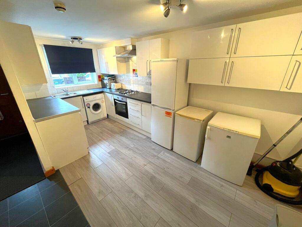 A spacious and modern kitchenette equipped with...