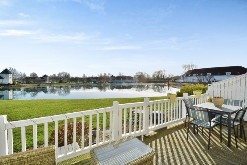 Decking, gardens and a lake view