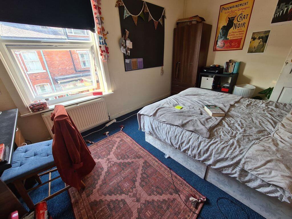 A warm and inviting double bedroom featuring a ...