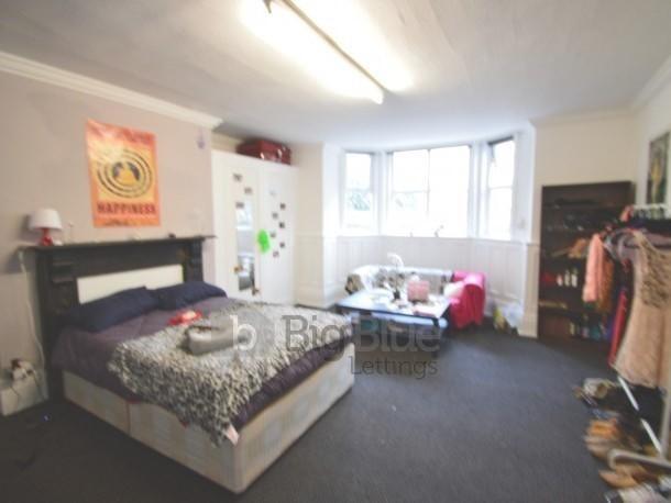 Bright and spacious bedroom featuring a comfort...
