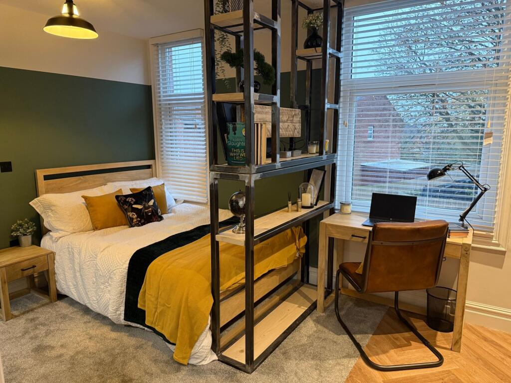 A stylish double bedroom featuring a comfortabl...