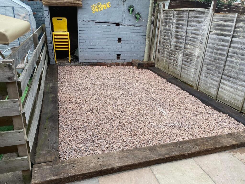 A well-maintained garden area featuring a spaci...