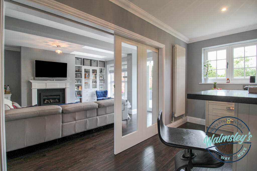 Concealed sliding doors between kitchen &amp; family r