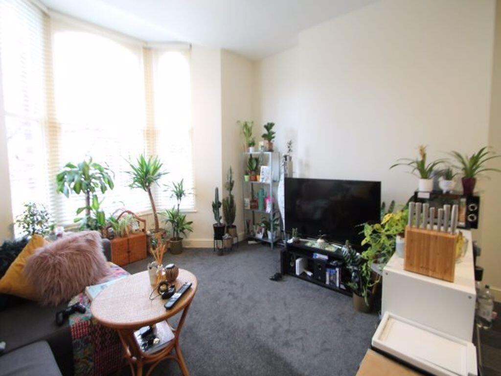 Bright and welcoming living room with ample nat...