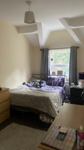 Bright, characterful bedroom with exposed ceili...
