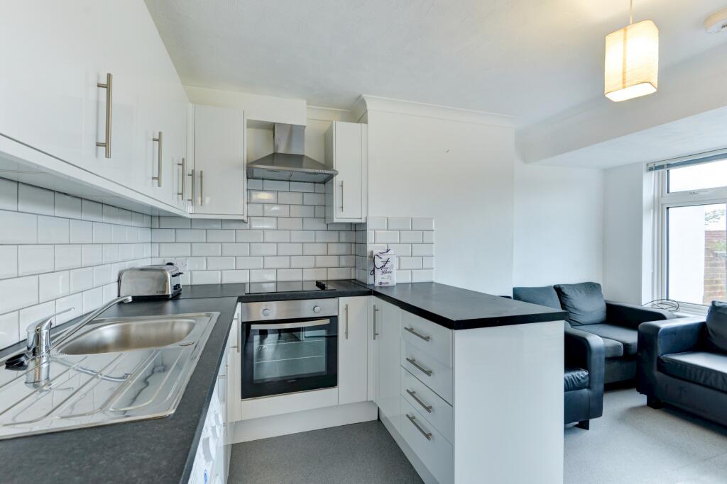 Bright and modern kitchen featuring sleek white...