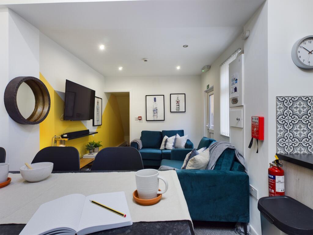 A spacious and inviting modern living room, per...