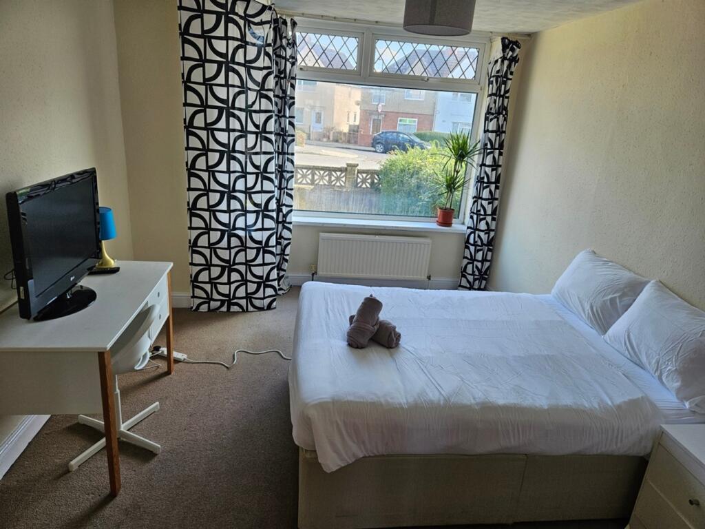 A bright and inviting double bedroom featuring ...