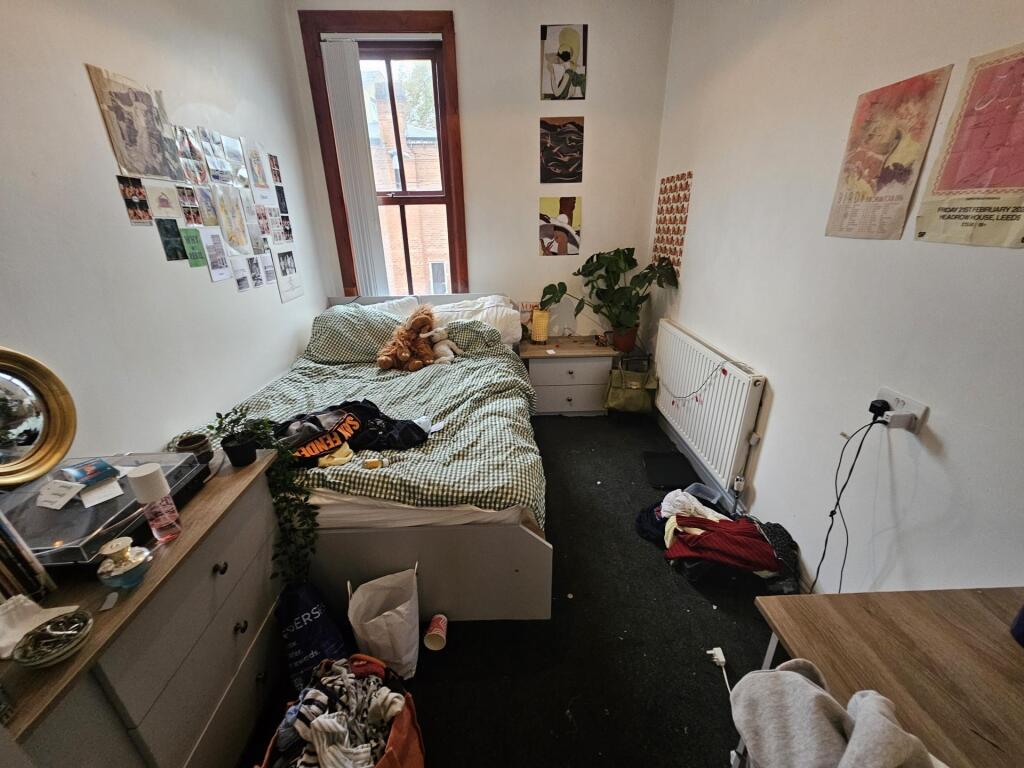 A cozy double bedroom featuring a large bed, a ...
