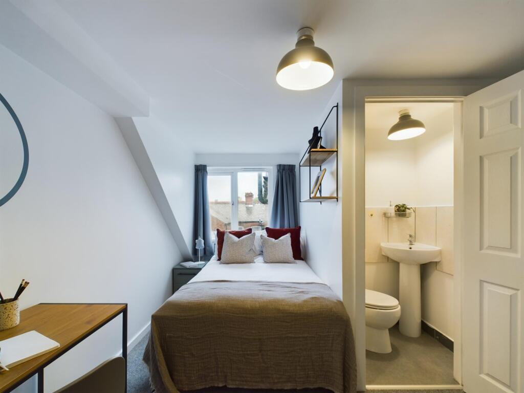 A bright and inviting double bedroom featuring ...