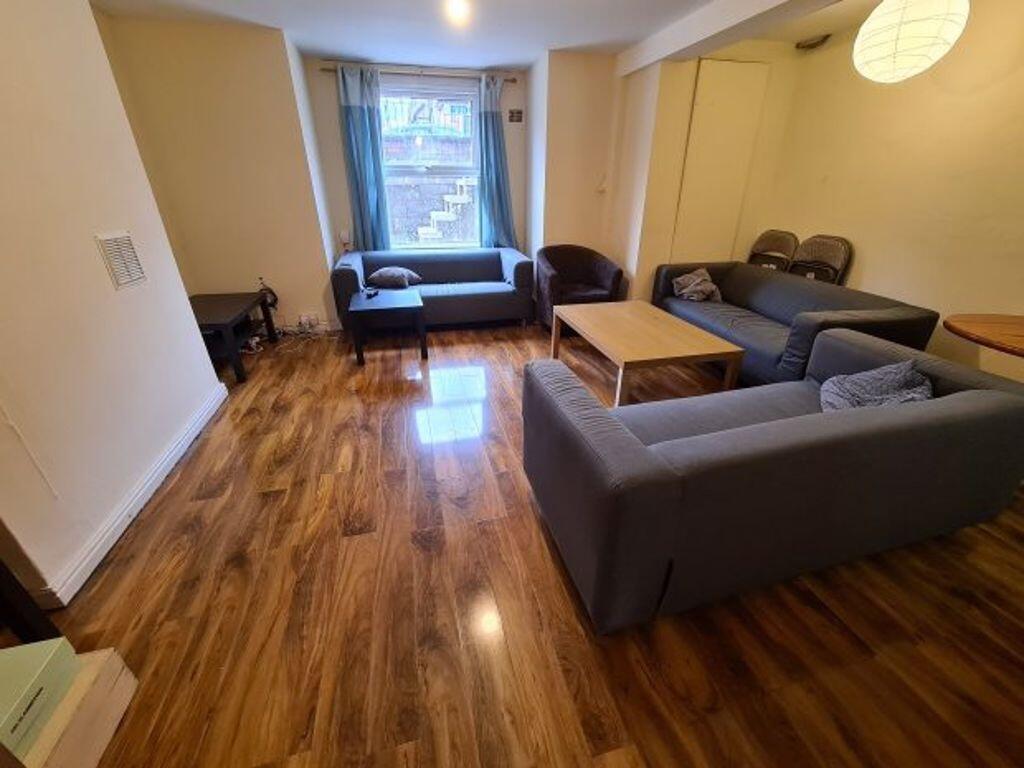 A modern living room featuring polished wooden ...