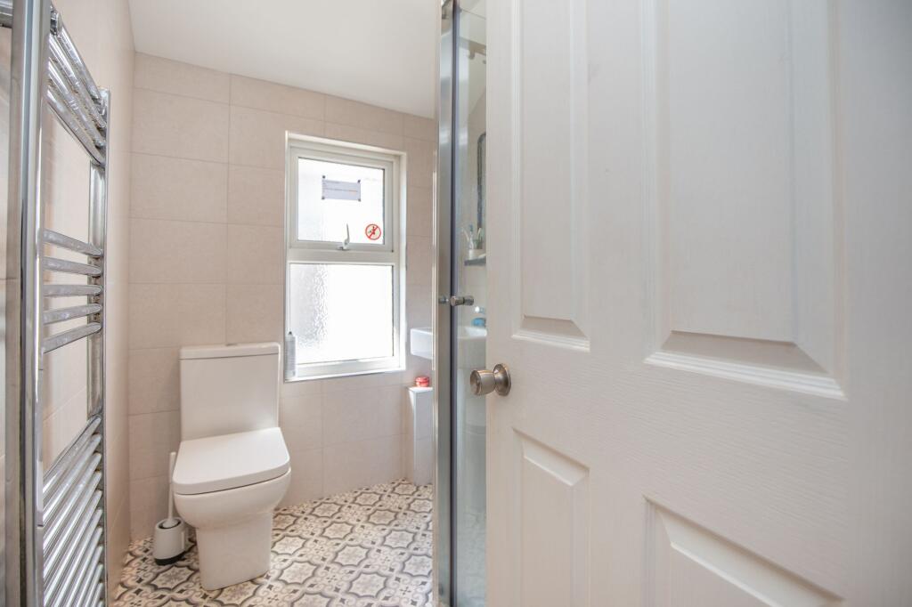 A bright, well-maintained bathroom featuring pa...