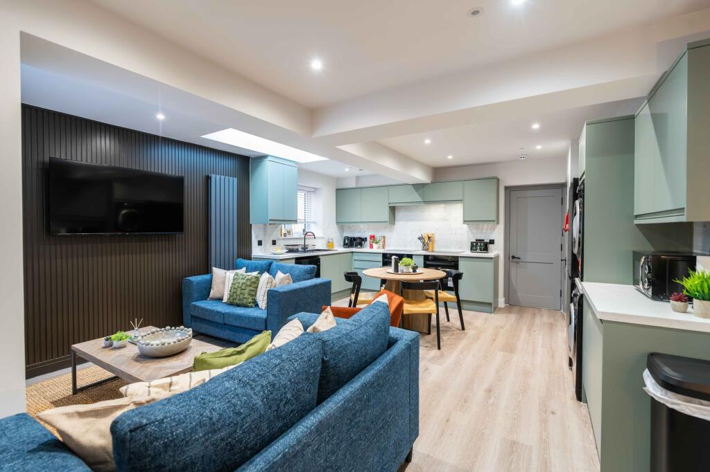 A modern, spacious living room featuring comfor...