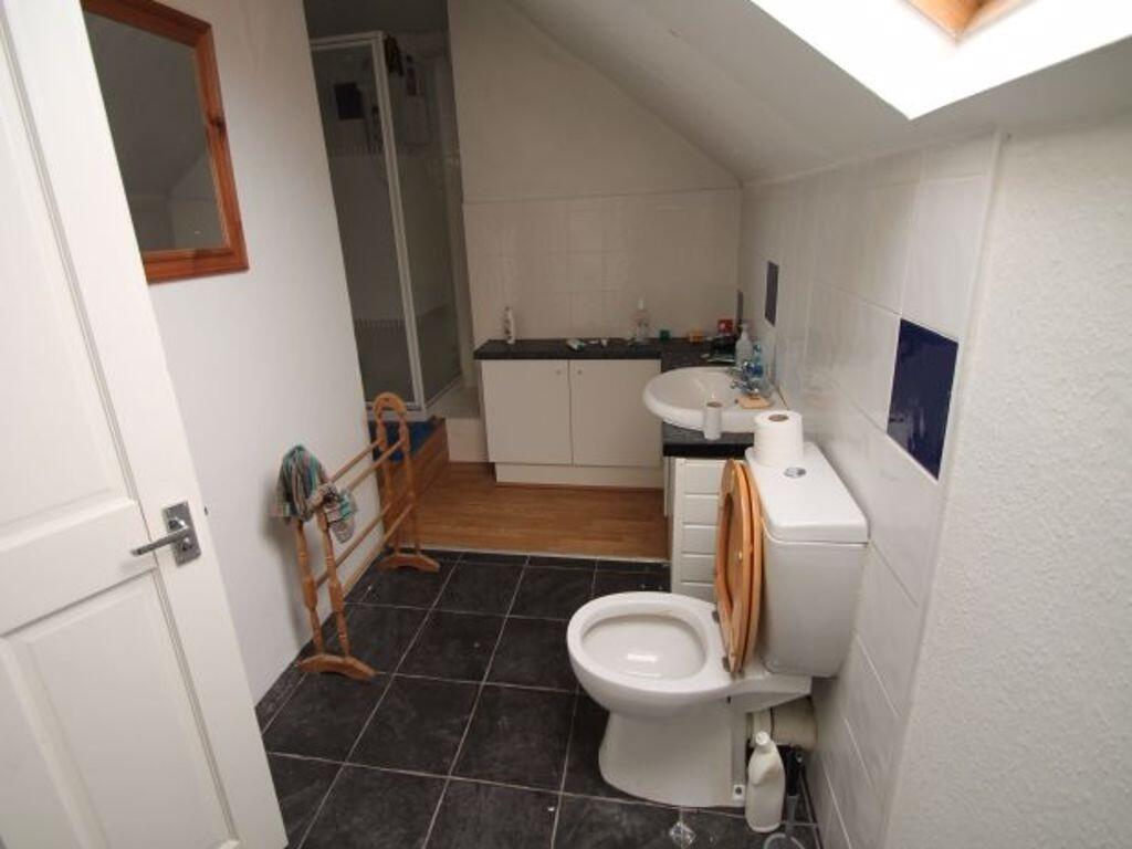 A clean and functional bathroom featuring a whi...