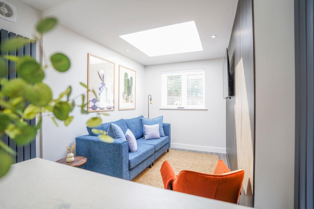 Bright and modern living room featuring a cozy ...