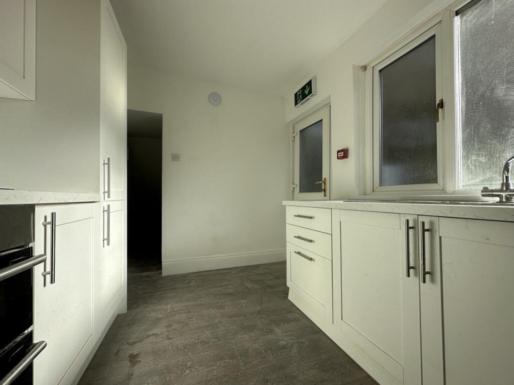 A modern kitchenette with ample storage and nat...