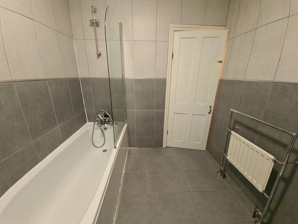 Spacious bathroom featuring a modern bathtub wi...