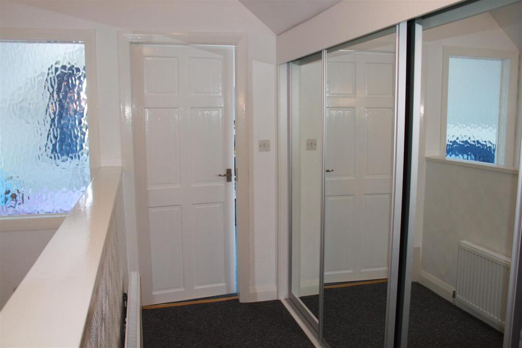 A staircase from the hall leads to  First Floor la