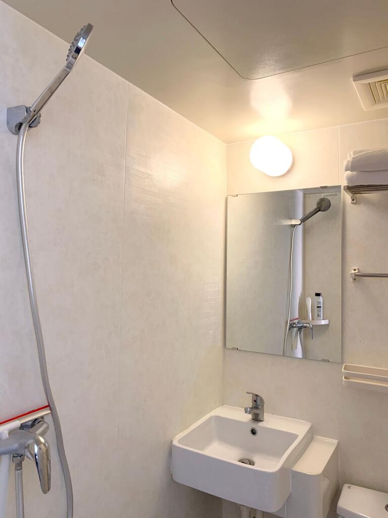 Bright and clean bathroom featuring a modern si...