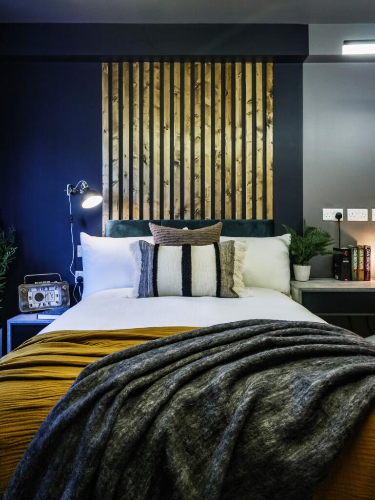 A stylish and cozy double bedroom featuring a n...