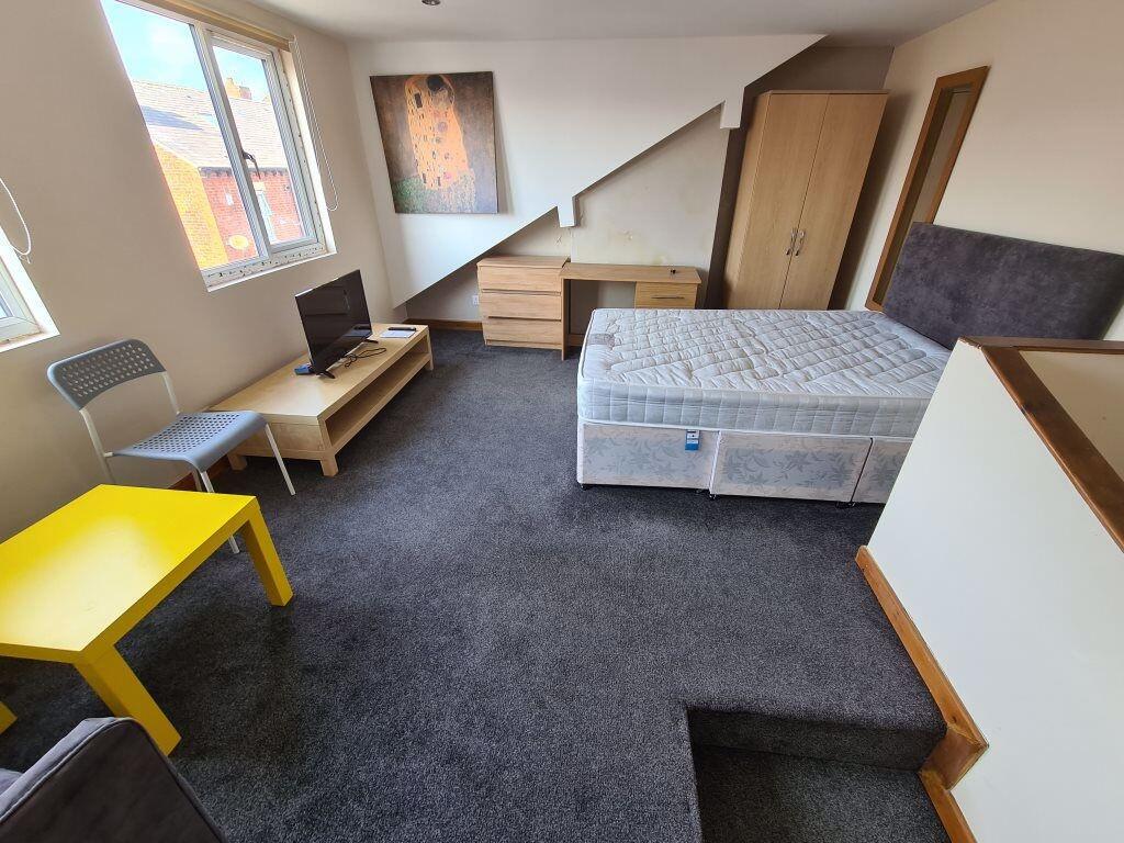 Bright and spacious bedroom featuring a large d...