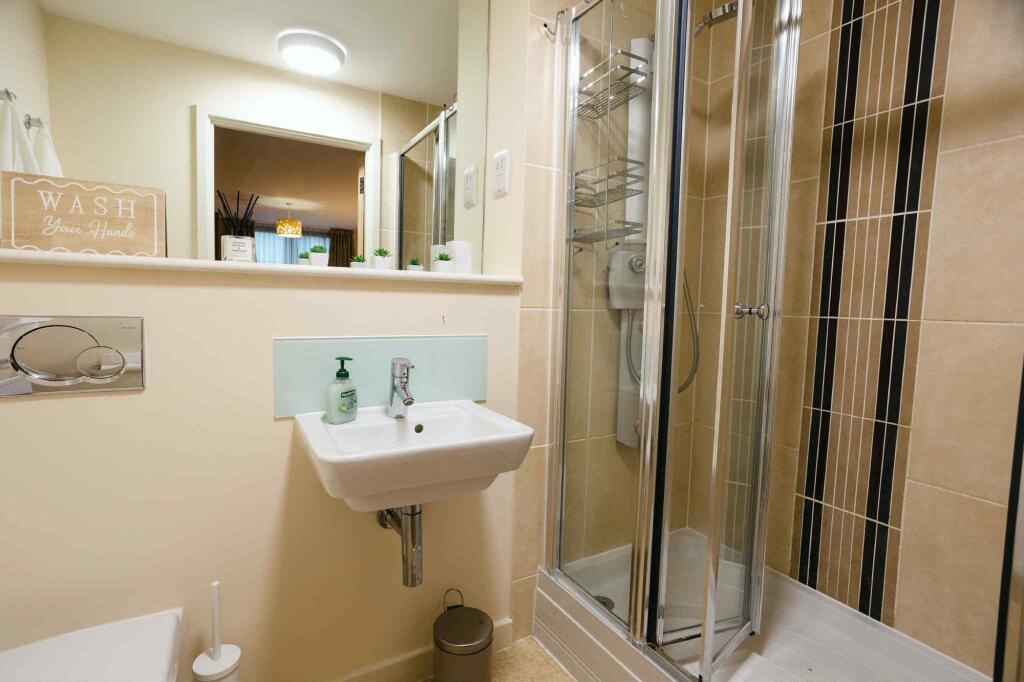 A modern bathroom featuring a clean sink area w...