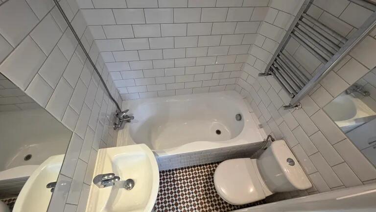 A clean and modern bathroom suite featuring a b...