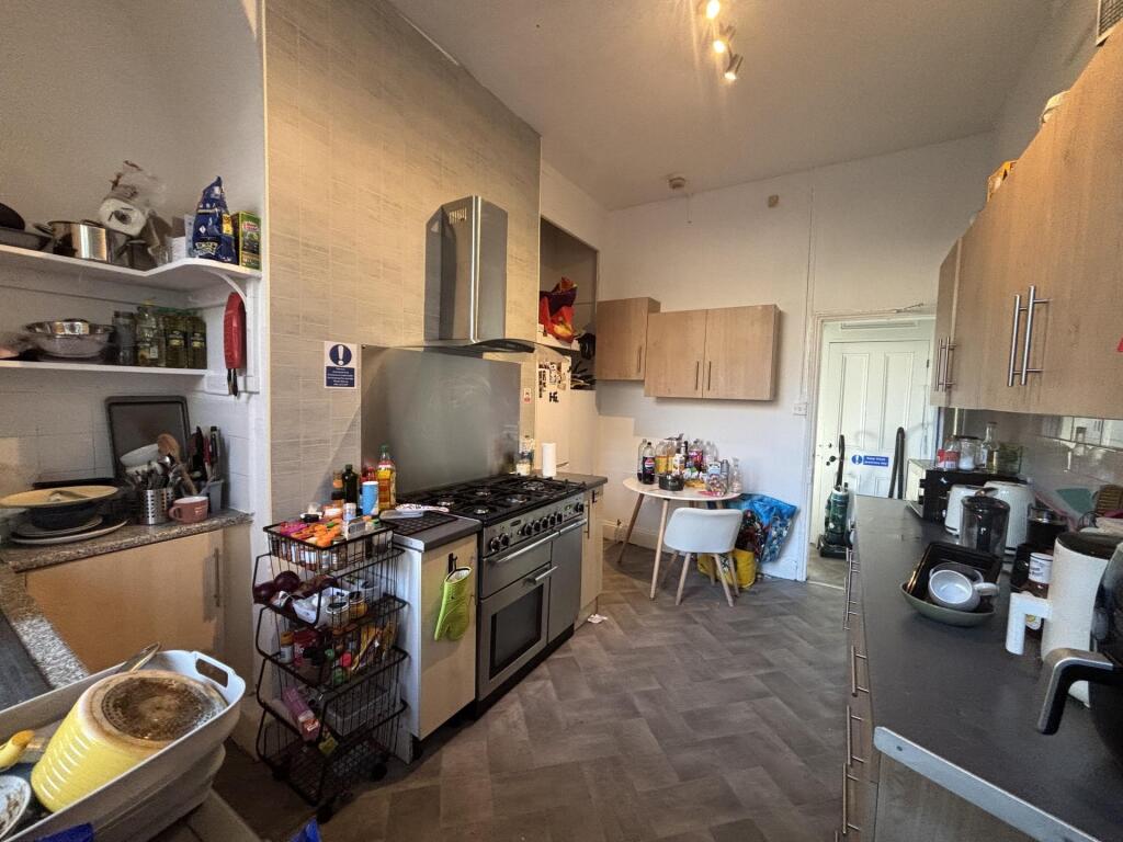 Bright, well-equipped galley kitchen with full-...